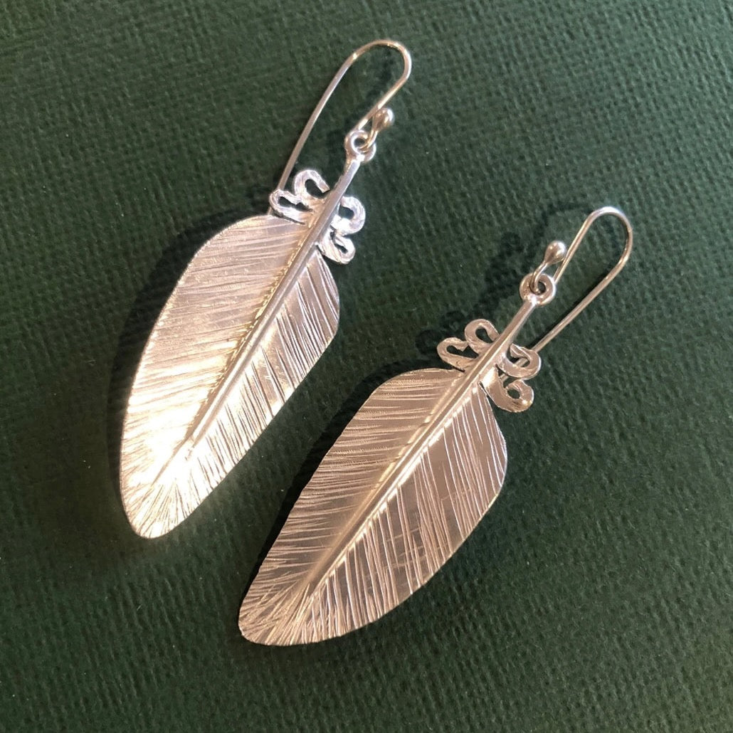 Feather earrings made from silver.