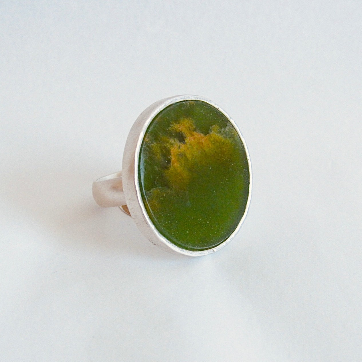Silver ring with circular green stone