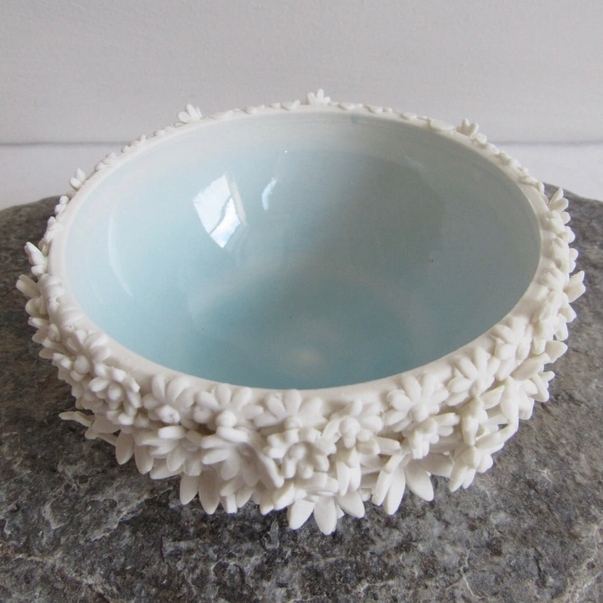 Blue bowl with white outside decorated with 3D flowers