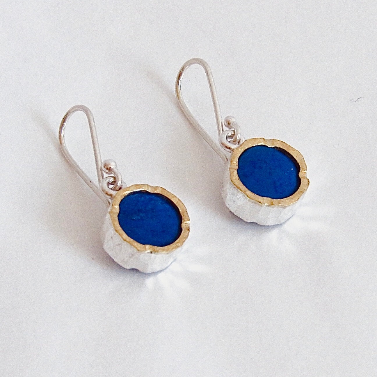 Silver and gold earrings with a blue centre