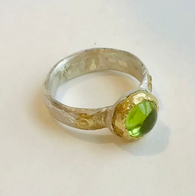 Polished peridot, gold and silver ring